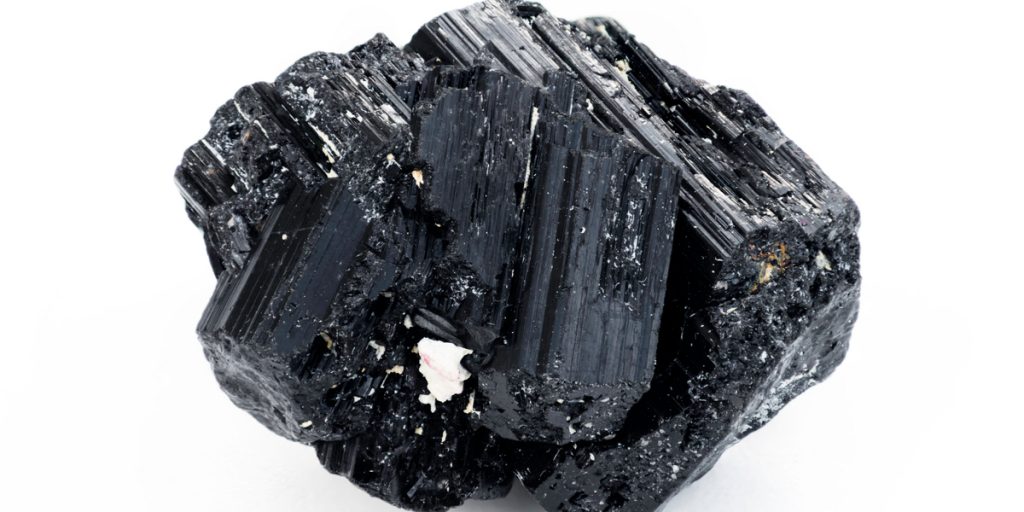 Close up of black tourmaline mineral with white background
