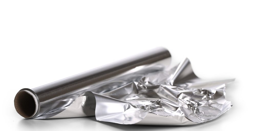 Roll of silver aluminum foil with 12 inches unrolled and partially crumpled